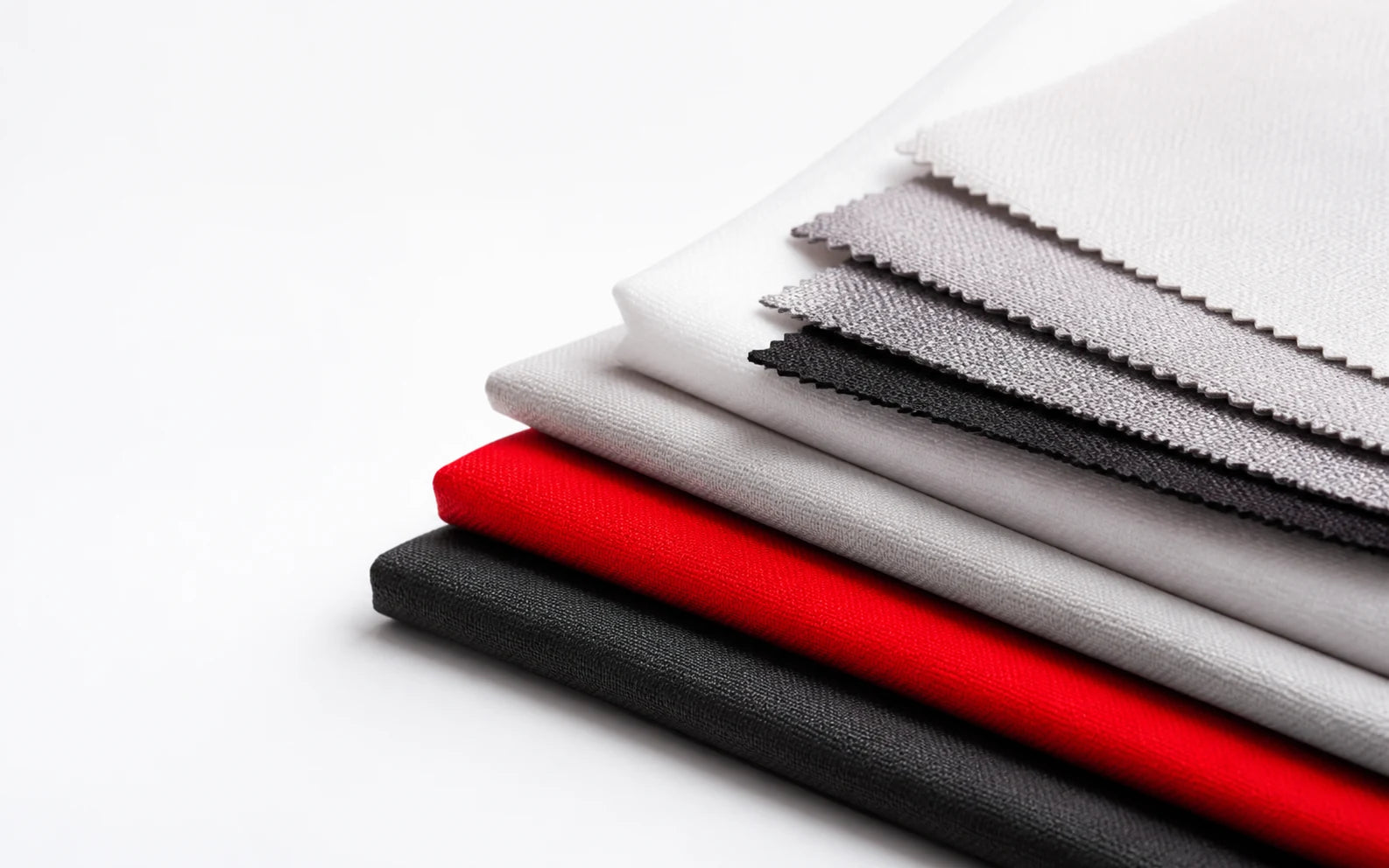 Layered premium fabric swatches in Fabricis brand colors